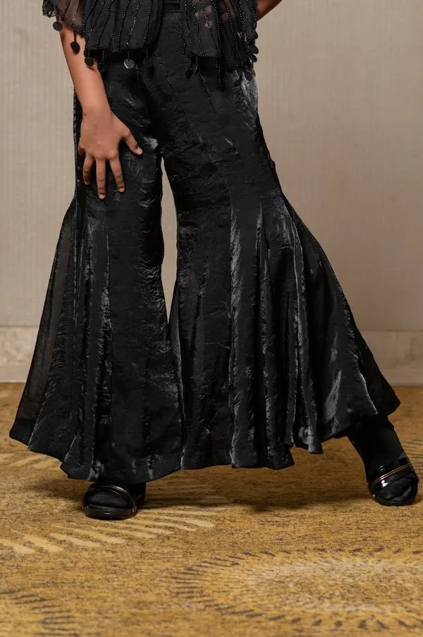 Chic black ensemble with a beaded cape and flared pants, perfect for making a stylish statement at any occasion